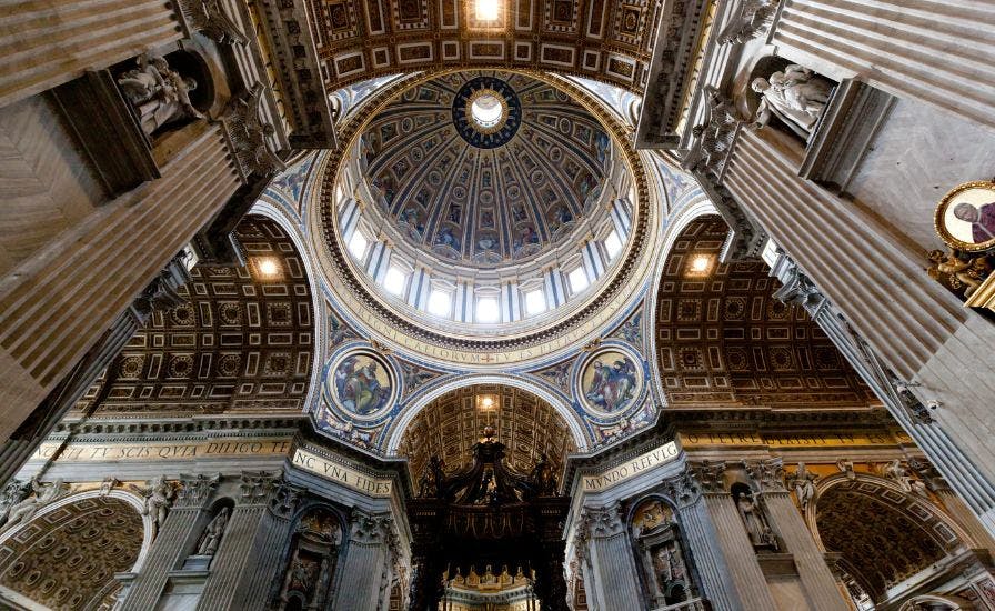 Ceiling of St. Peter's Basilica adorned with statues, showcasing the architectural marvel of the cathedral's dome