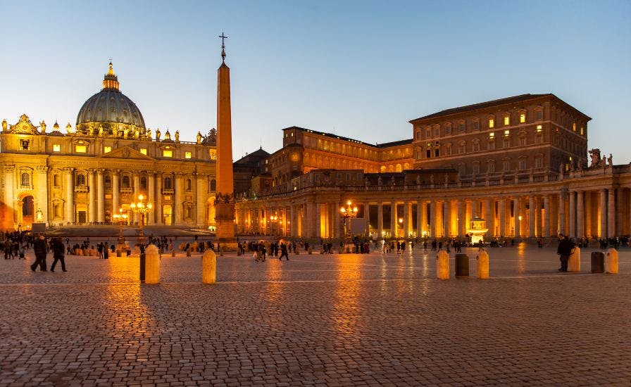 St. Peter's Basilica in Vatican City, illuminated at dusk, showcasing its stunning architectural beauty
