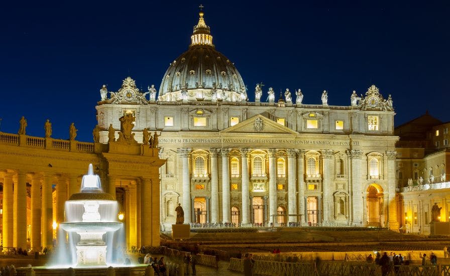 The Vatican at night with St. Peter's Basilica illuminated in the background