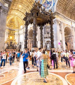 Visitors admiring masterpieces inside St. Peter's Basilica, Vatican City.