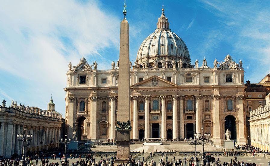 A-stunning-building-with-a-towering-column-featuring-the-magnificent-St.-Peters-Basilica