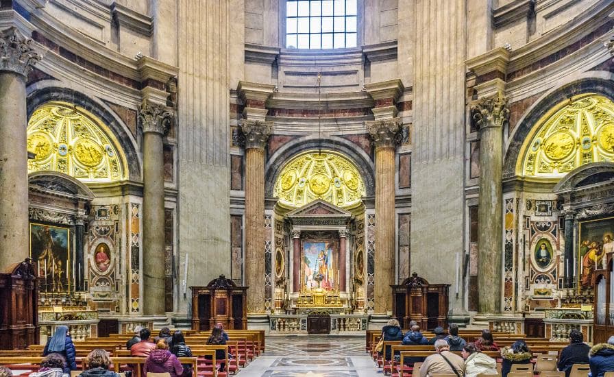 Interior-of-St.-Peters-Basilica-showing-people-seated-in-pews-during-a-church-service