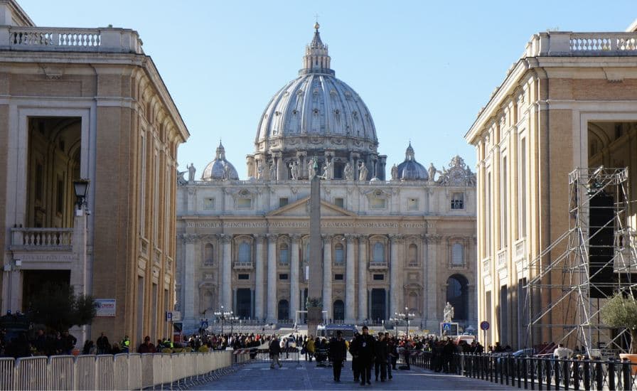Exterior view of St. Peter's Basilica in Vatican City, showcasing its iconic dome and intricate architecture.