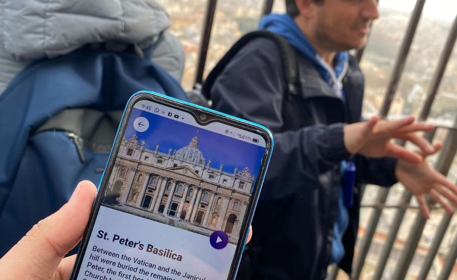 Individual holding up smartphone with church photo, St. Peter Basilica tour