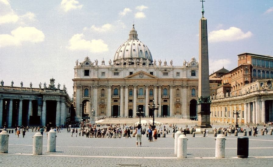 A bustling, grand building filled with numerous individuals. Discover the wonders of St. Peter's Basilica